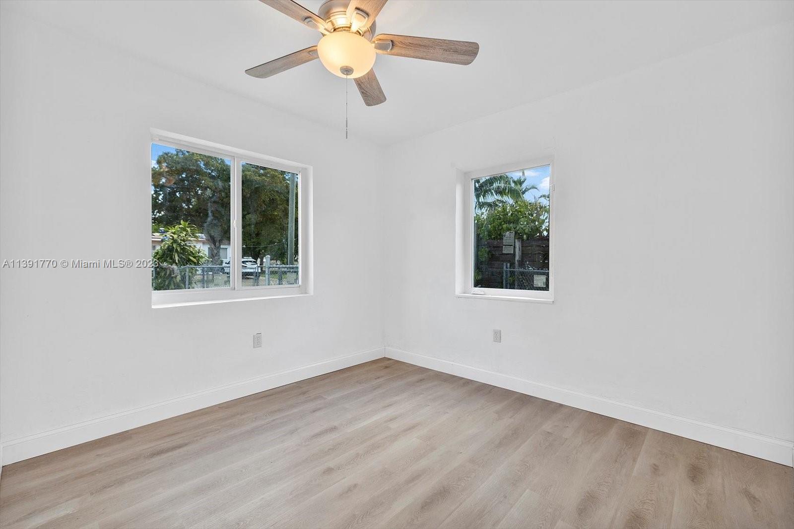 6110 Southwest 20th Street Miami, FL 33155 - Photo 18 of 29 an empty room with a window and a fan