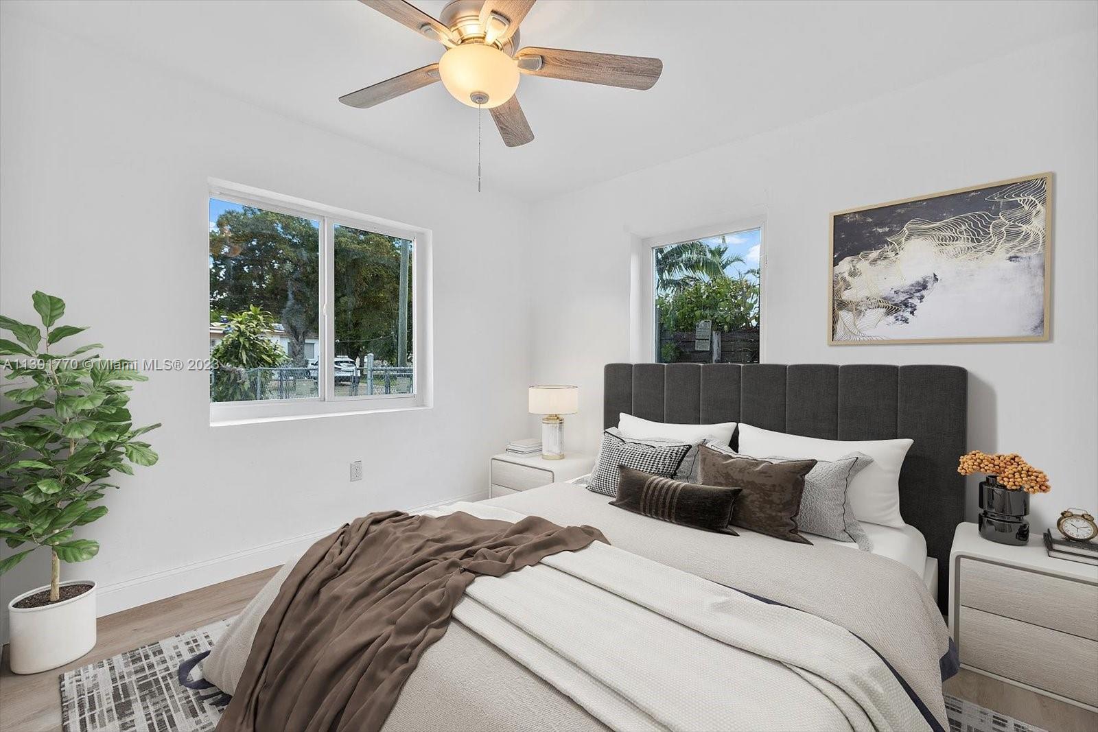 6110 Southwest 20th Street Miami, FL 33155 - Photo 19 of 29 a bedroom with bed and a potted plant