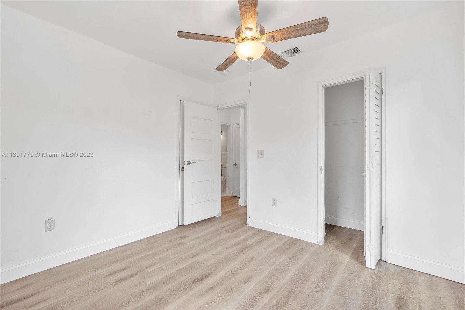 6110 Southwest 20th Street Miami, FL 33155 - Photo 20 of 29 an empty room with wooden floor and ceiling fan