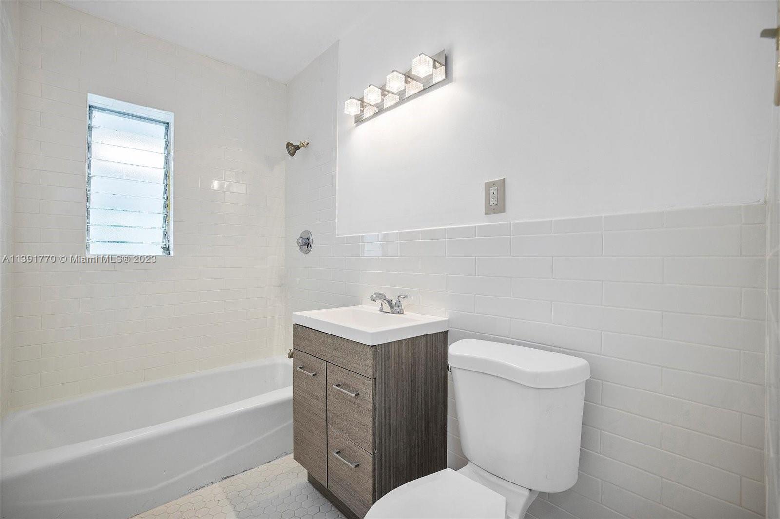 6110 Southwest 20th Street Miami, FL 33155 - Photo 23 of 29 a bathroom with a sink toilet vanity and bathtub
