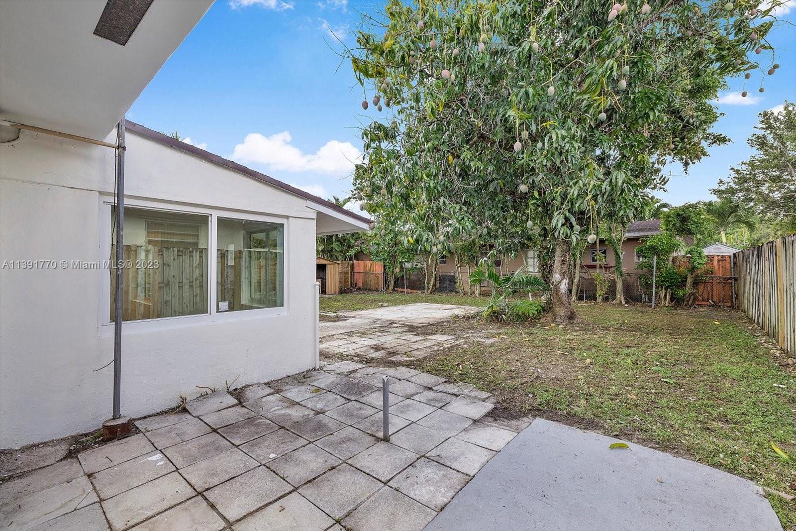 6110 Southwest 20th Street Miami, FL 33155 - Photo 27 of 29 a view of a house with a yard