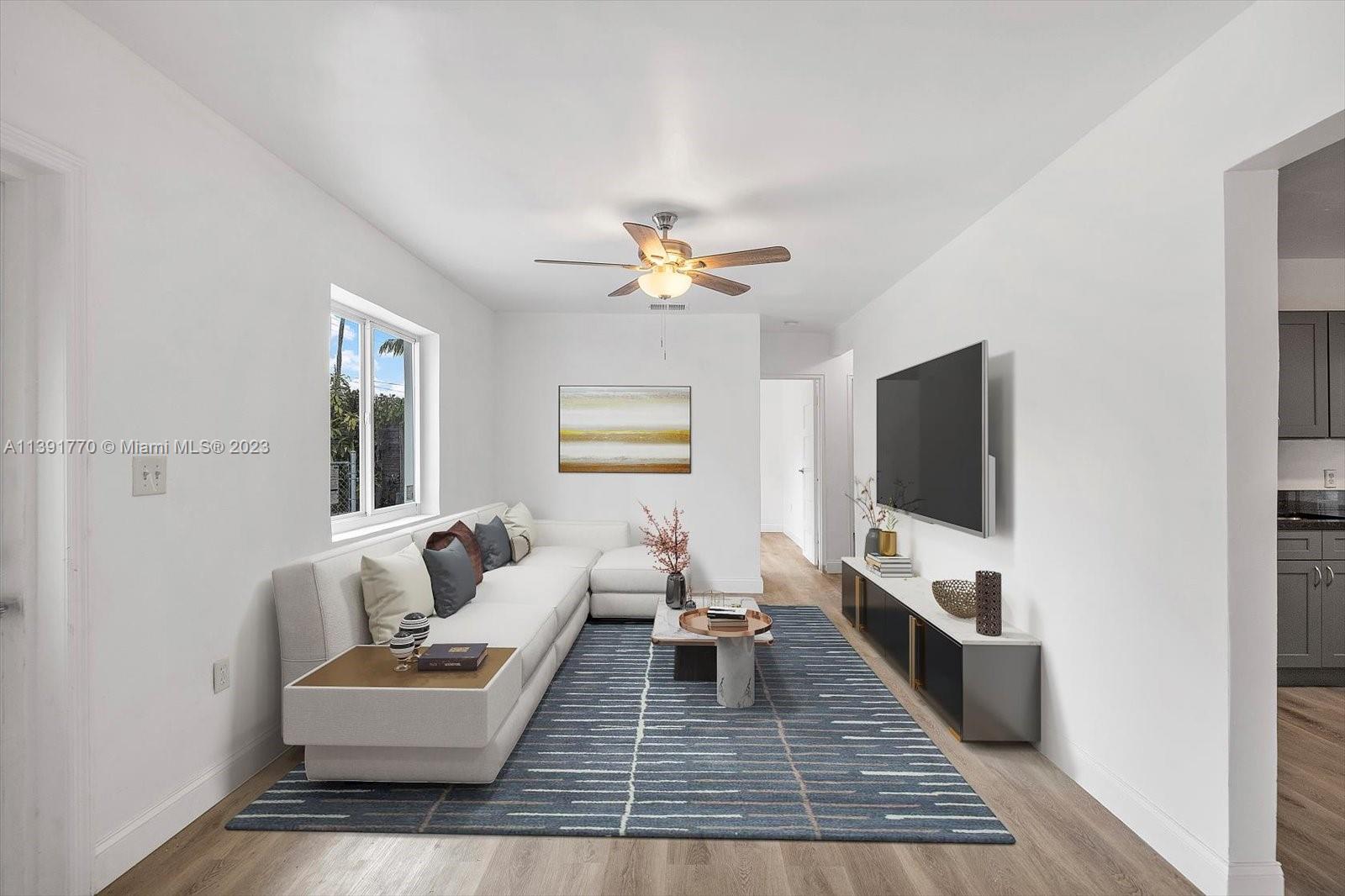 6110 Southwest 20th Street Miami, FL 33155 - Photo 5 of 29 a living room with furniture and a flat screen tv