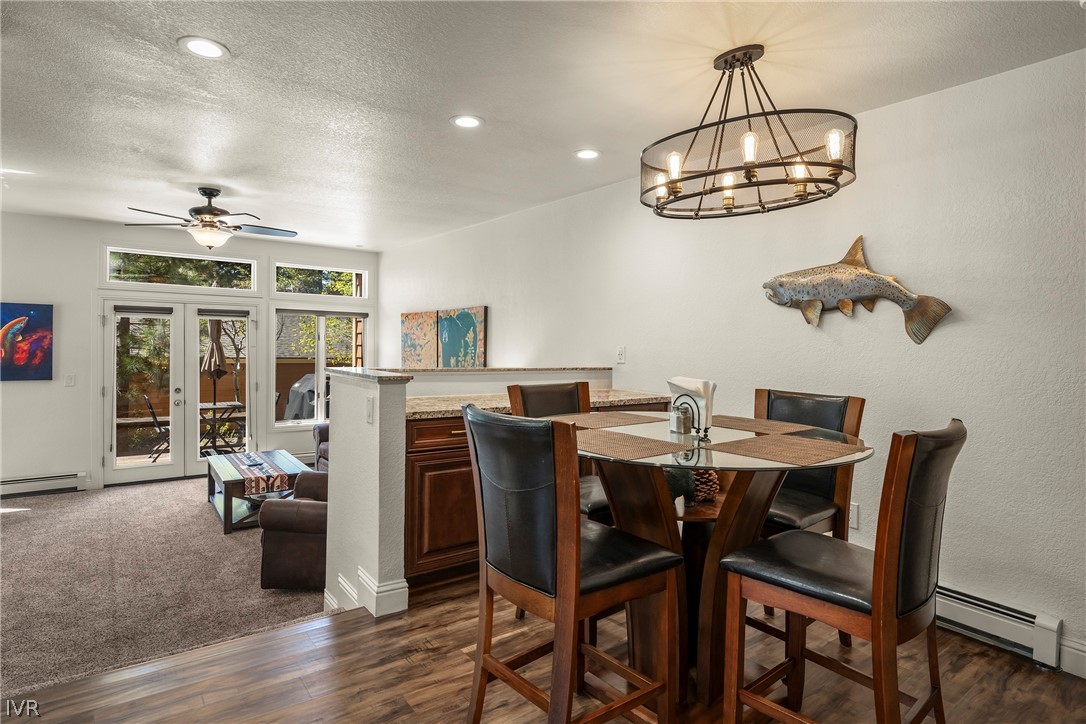 939 Incline Way, Unit 200 Incline Village, NV 89451 - Photo 7 of 27 a view of a dining room with furniture wooden floor and chandelier
