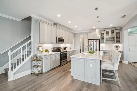 a kitchen with microwave a stove and cabinets