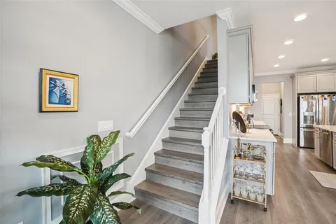 a view of entryway and hall with wooden floor
