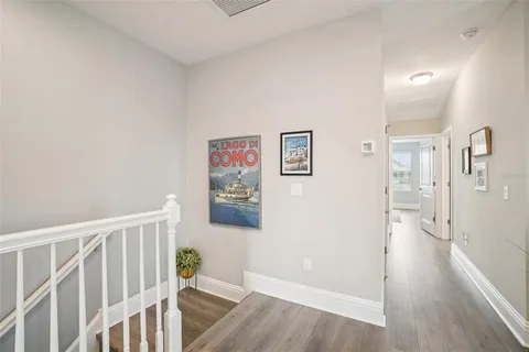 a view of a hallway with wooden floor and plants