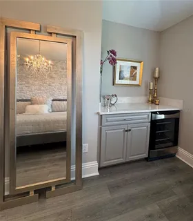 a bathroom with a double vanity sink a mirror and a bathtub