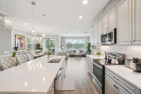 a kitchen with sink a stove and cabinets