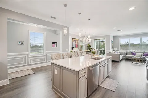 a view of a kitchen counter top space with furniture and wooden floor