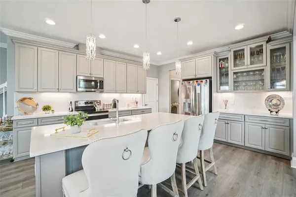 a kitchen with appliances a sink and cabinets