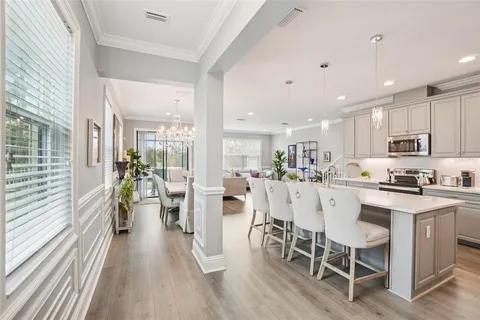 a large kitchen with a table and chairs