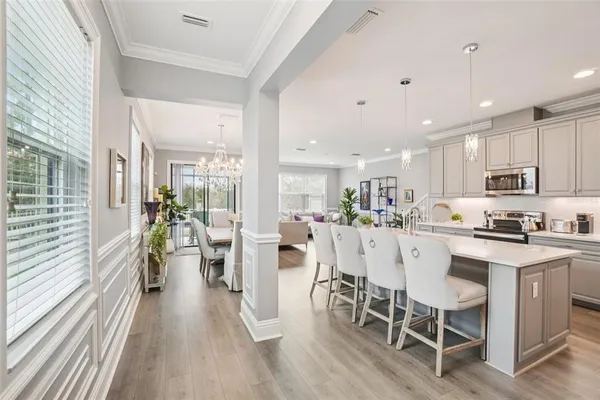 a large kitchen with a table and chairs