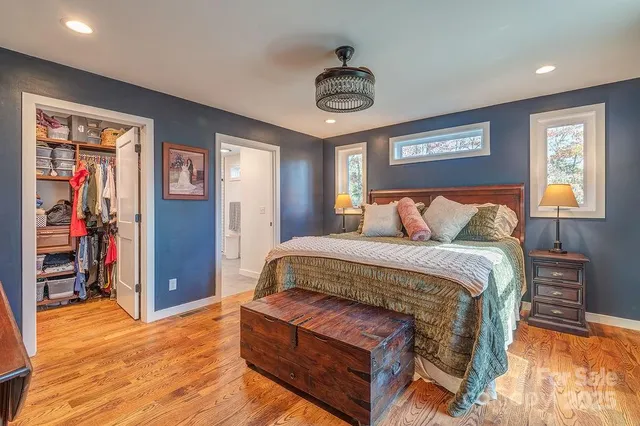 a bedroom with a bed and a chandelier