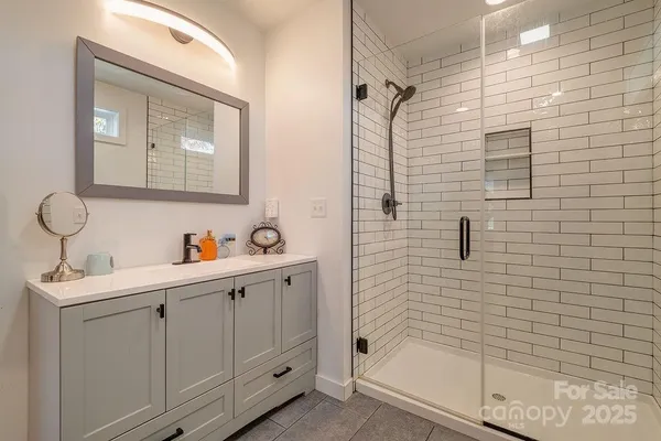 a bathroom with a bathtub a mirror a sink and vanity