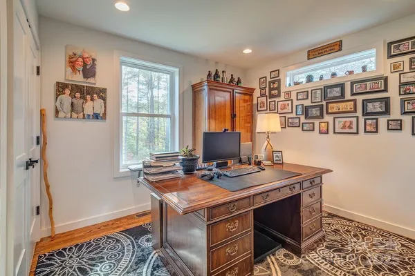 a view of a workspace with furniture and a window