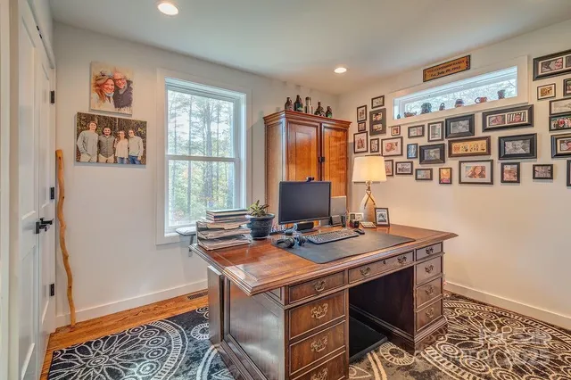 a view of a workspace with furniture and a window