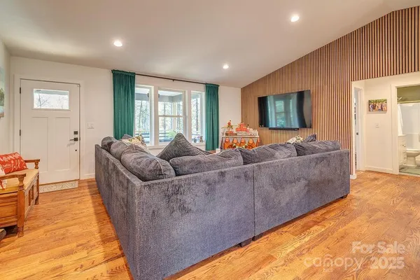 a living room with furniture and a flat screen tv