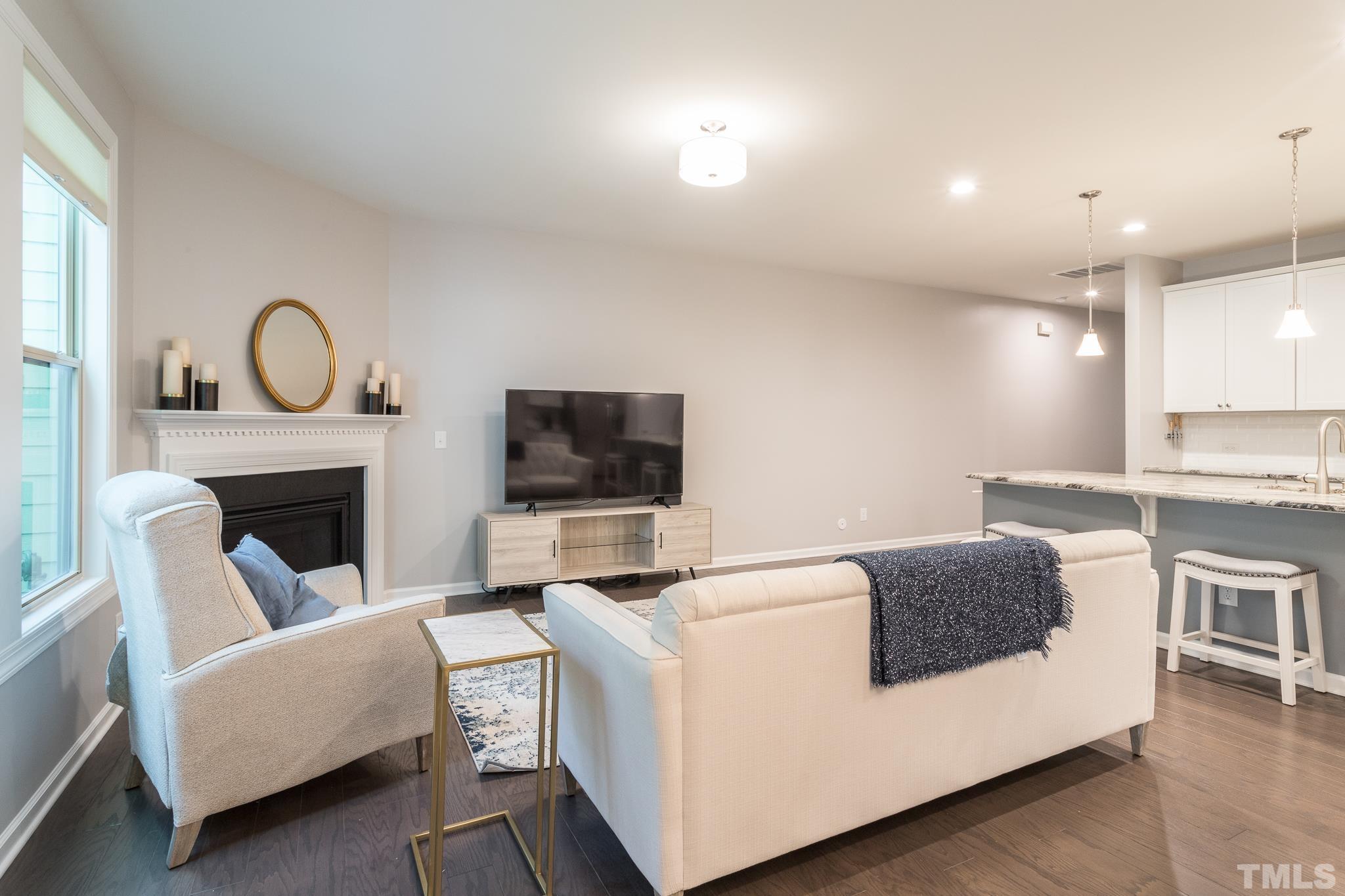 1015 Catch Fly Lane Durham, NC 27713 - Photo 3 of 18 a living room with furniture a fireplace and a flat screen tv