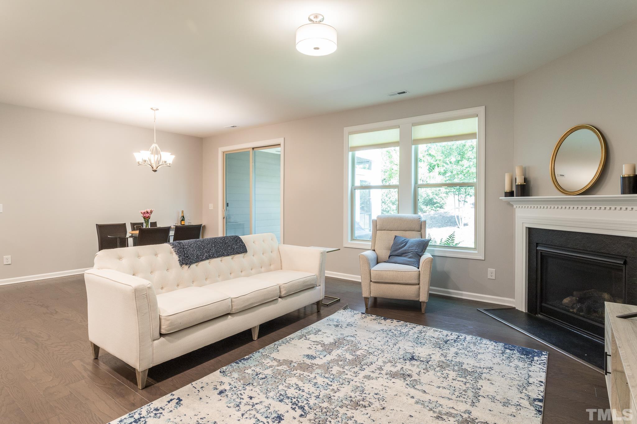 1015 Catch Fly Lane Durham, NC 27713 - Photo 4 of 18 a living room with furniture a fireplace and a large window