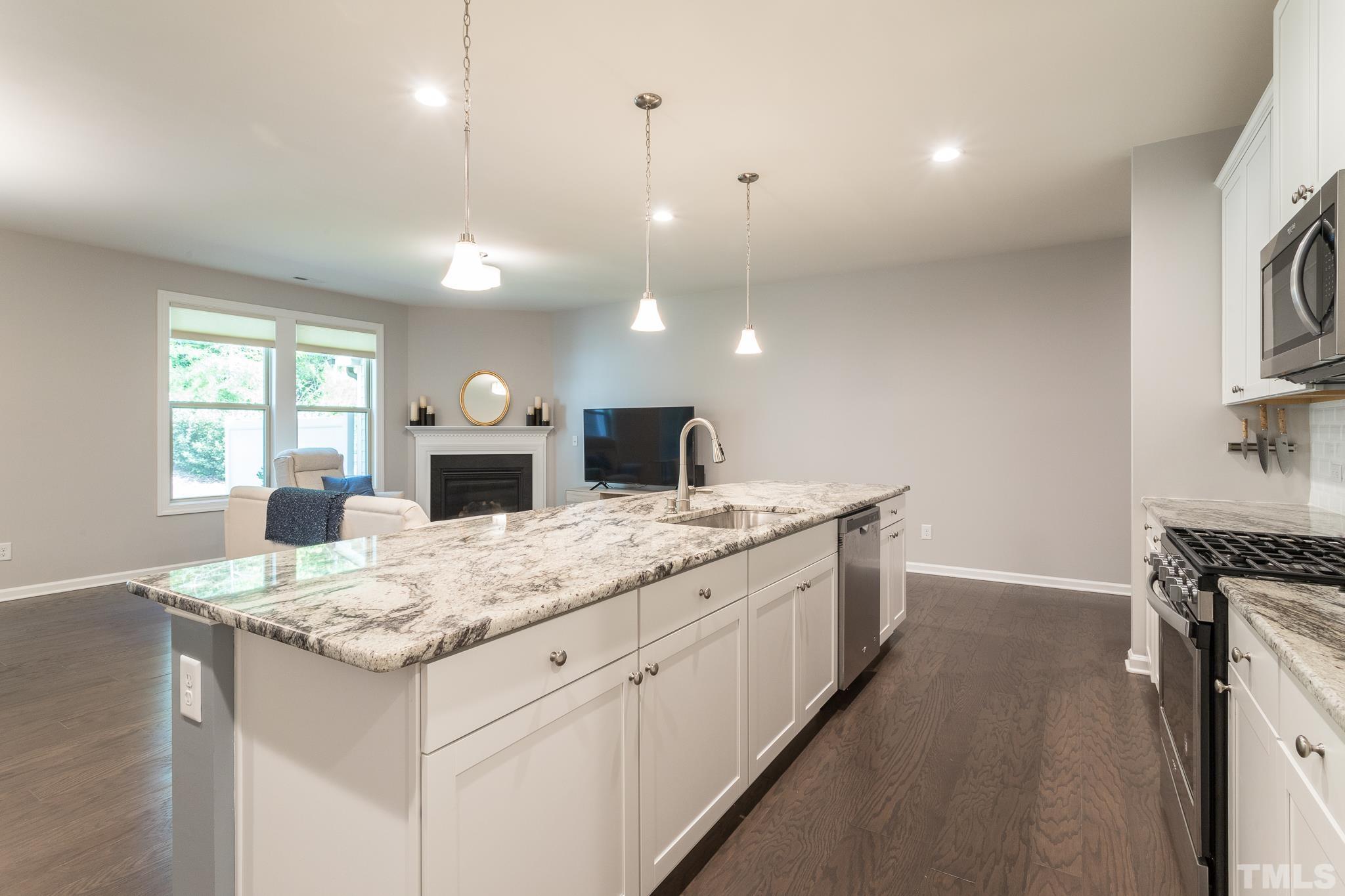 1015 Catch Fly Lane Durham, NC 27713 - Photo 8 of 18 a kitchen with a sink and a stove with wooden floor