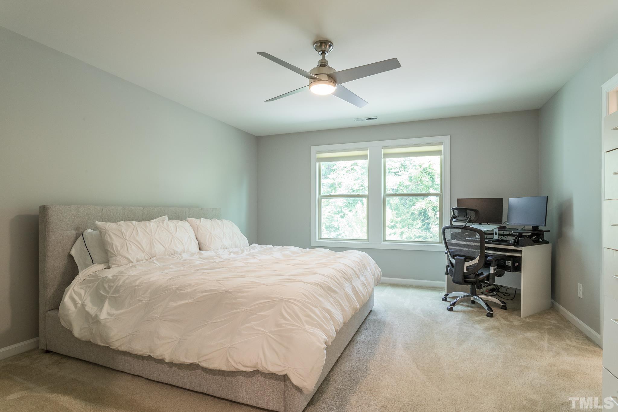 1015 Catch Fly Lane Durham, NC 27713 - Photo 9 of 18 a bedroom with a bed and a desk