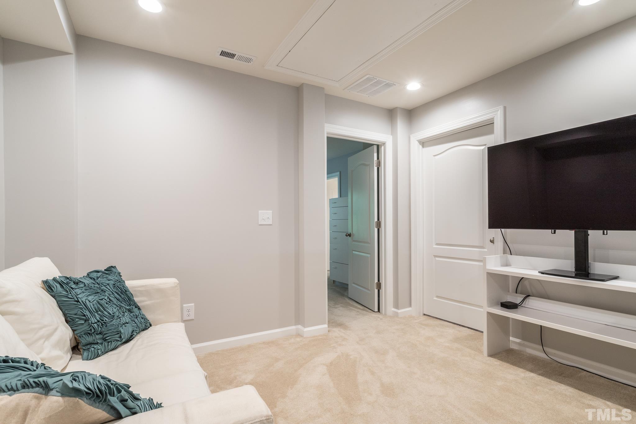1015 Catch Fly Lane Durham, NC 27713 - Photo 10 of 18 a living room with furniture and a flat screen tv