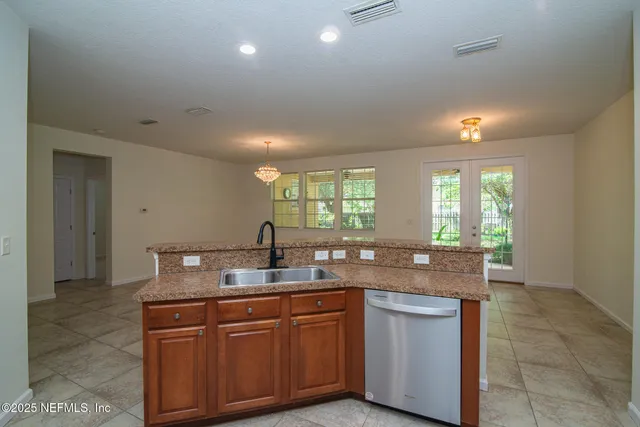 a kitchen with granite countertop a sink and a window
