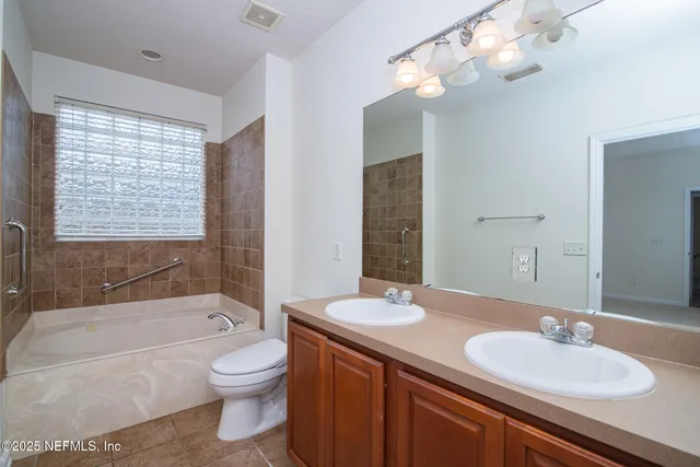 a bathroom with a sink a toilet and bathtub