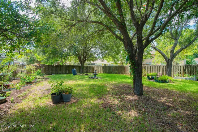 a view of a house with yard and sitting area
