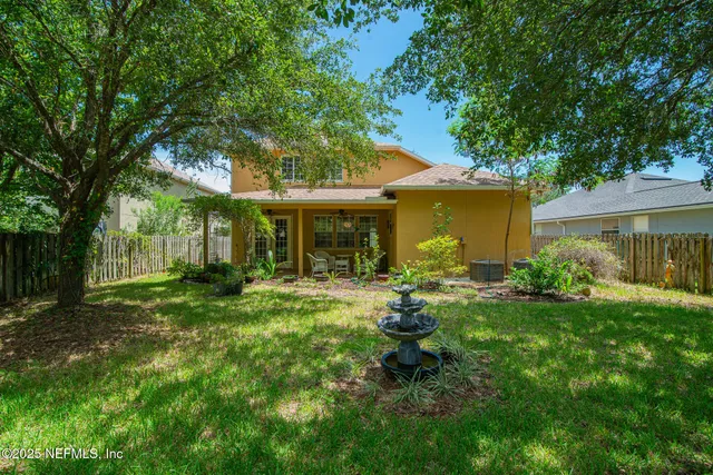 a view of a house with backyard sitting area and garden
