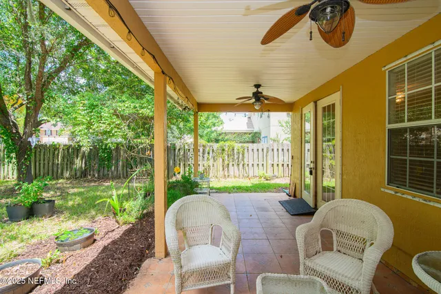 a balcony with table and chairs