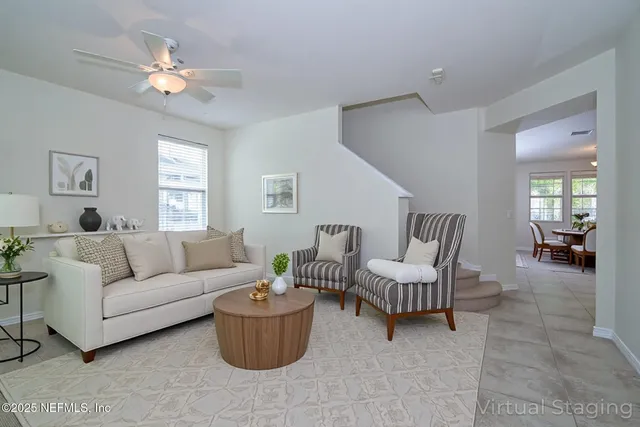 a living room with furniture and a chandelier
