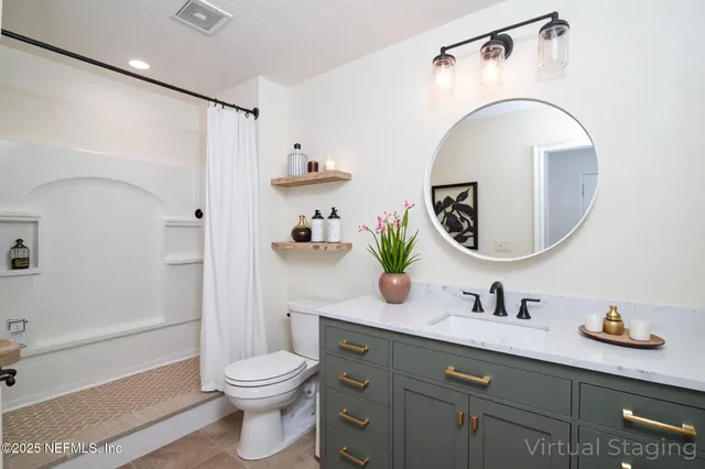 a bathroom with a toilet a sink and mirror