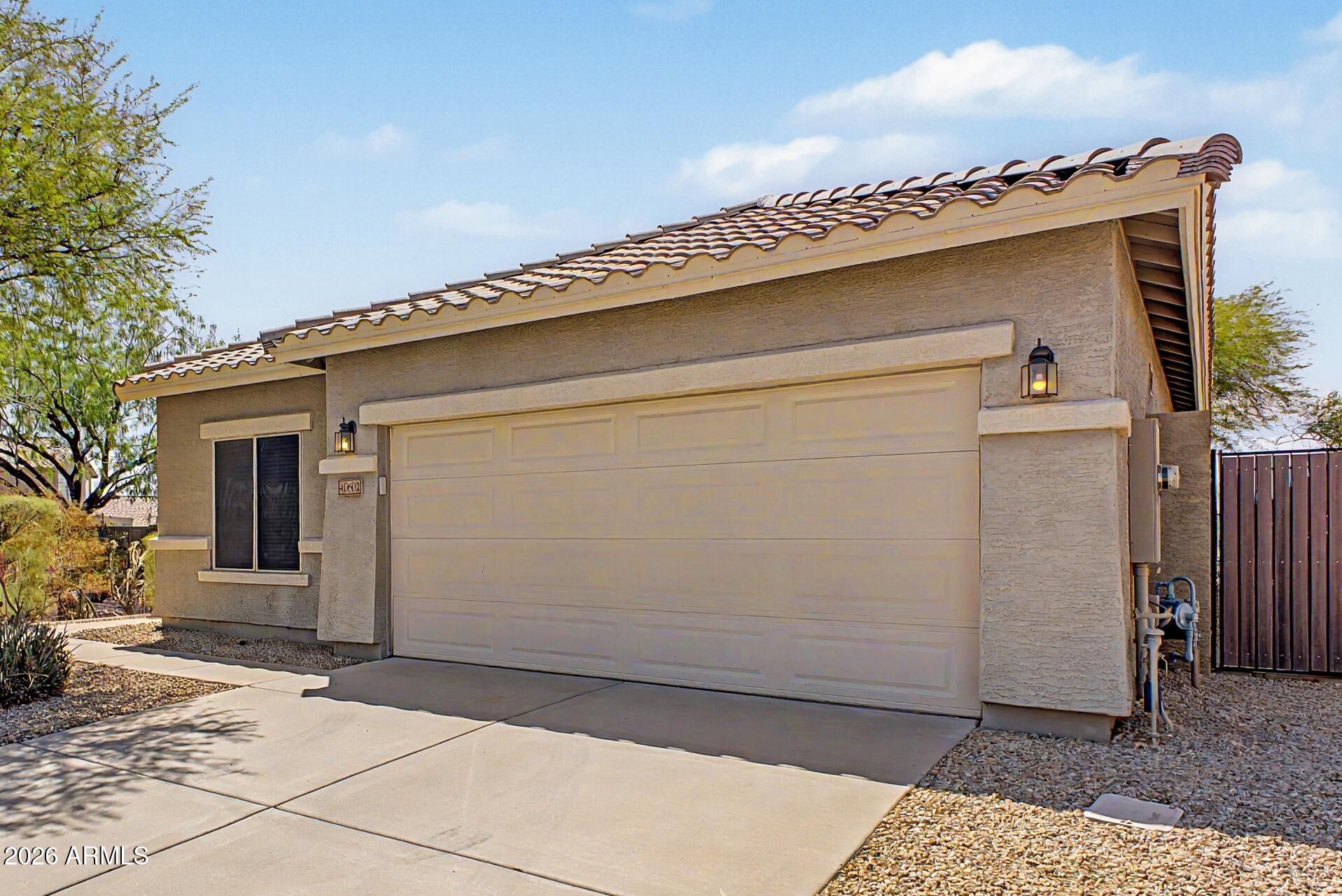 40602 North Apollo Way Anthem, AZ 85086 - Photo 3 of 38 a view of a house with a wooden fence