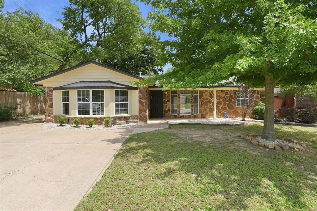 1108 Billie Ruth Lane Hurst, TX 76053 - Photo 22 of 27 Ranch-style residence featuring a stone and siding exterior, a prominent bay window, and a concrete driveway