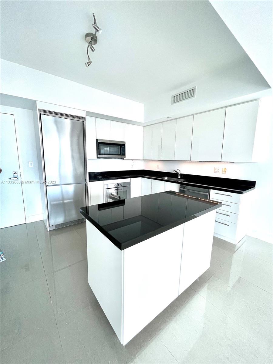 92 Southwest 3rd Street, Unit 4111 Miami, FL 33130 - Photo 1 of 24 a kitchen with a sink stove and microwave