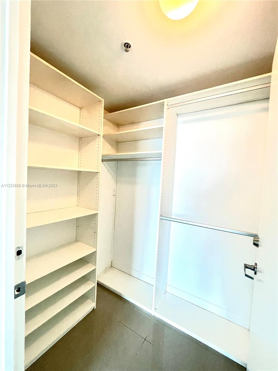 92 Southwest 3rd Street, Unit 4111 Miami, FL 33130 - Photo 12 of 24 a view of walk in closet with empty racks