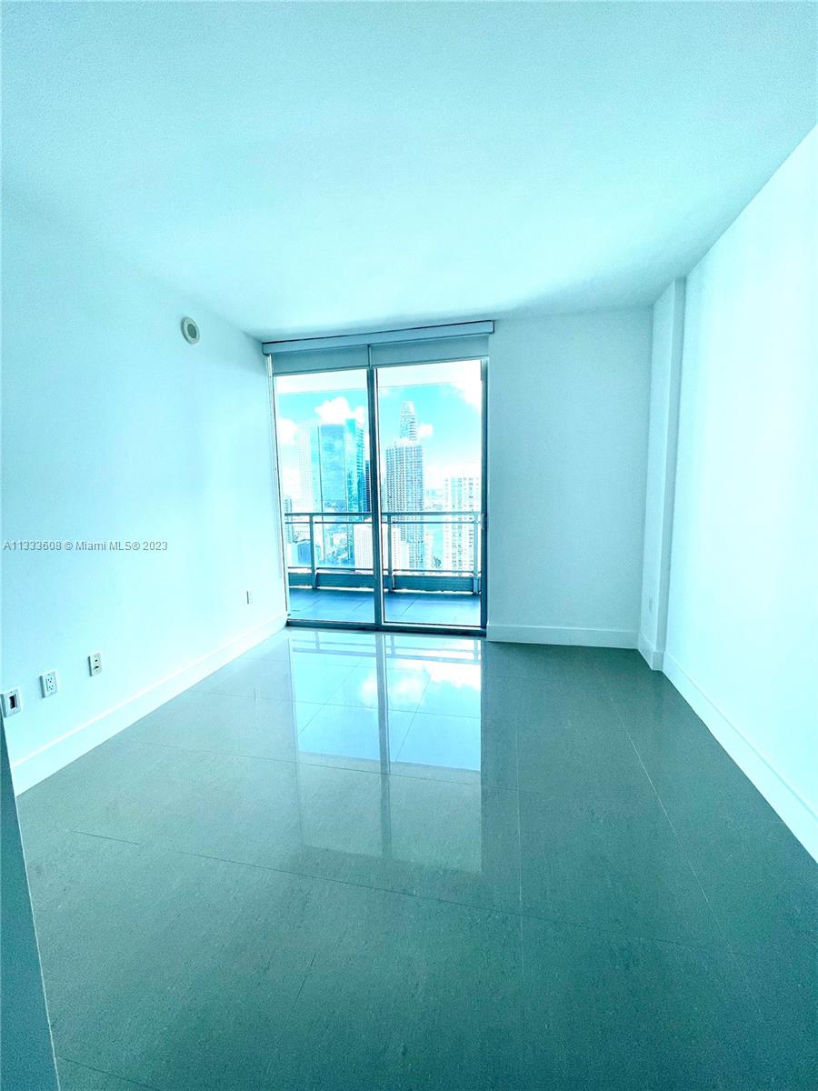 92 Southwest 3rd Street, Unit 4111 Miami, FL 33130 - Photo 13 of 24 an empty room with wooden floor and windows
