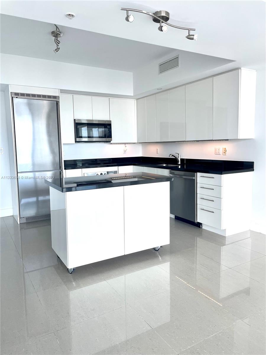 92 Southwest 3rd Street, Unit 4111 Miami, FL 33130 - Photo 2 of 24 a kitchen with stainless steel appliances granite countertop a stove and a sink