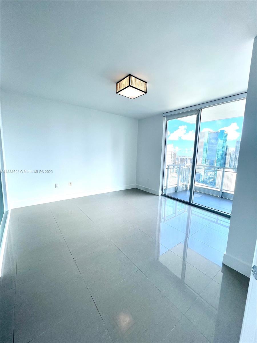 92 Southwest 3rd Street, Unit 4111 Miami, FL 33130 - Photo 8 of 24 an empty room with windows and entrance