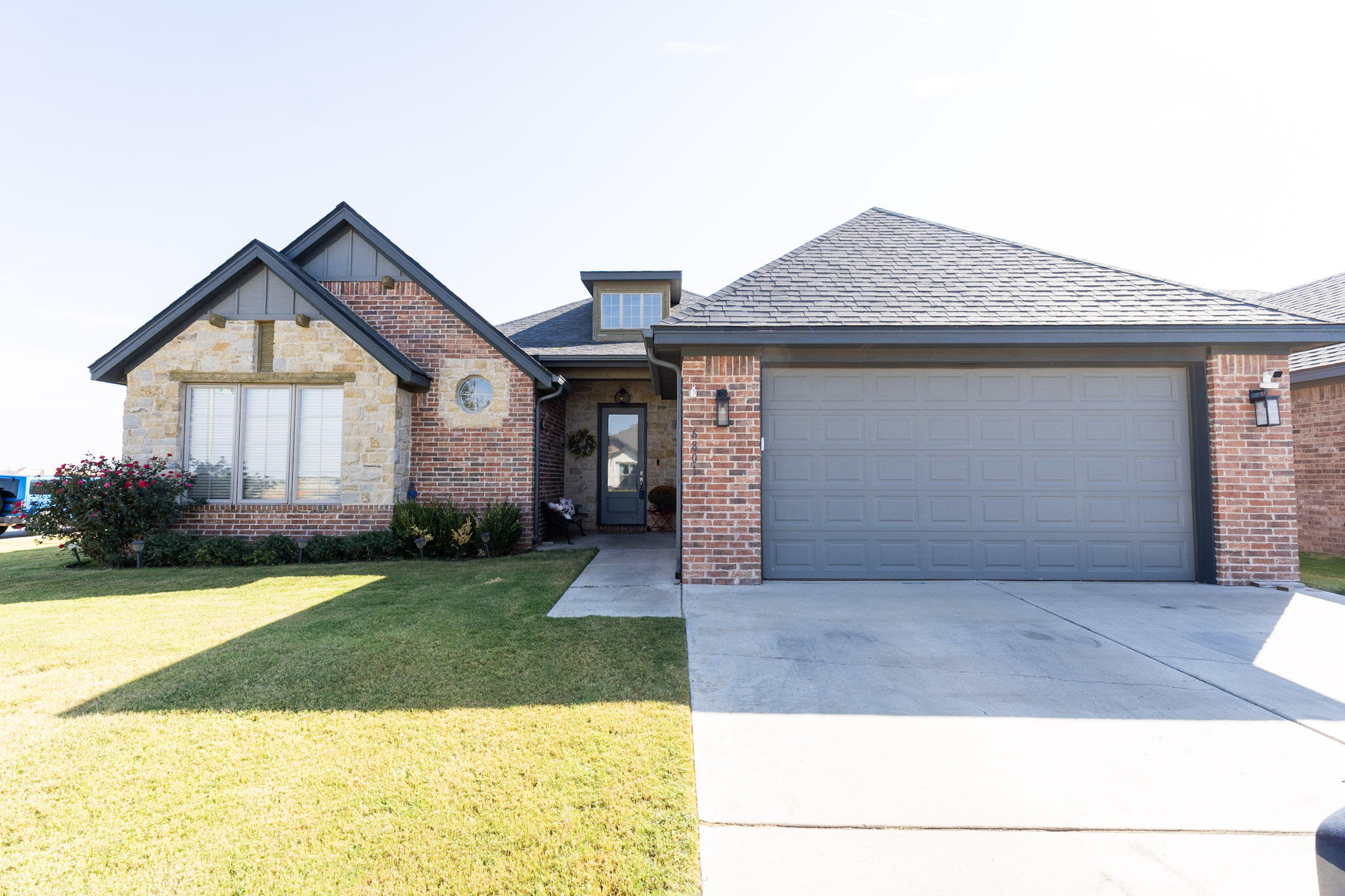 6801 51st Street Lubbock, TX 79407 - Photo 1 of 19 a front view of a house with a yard and garage