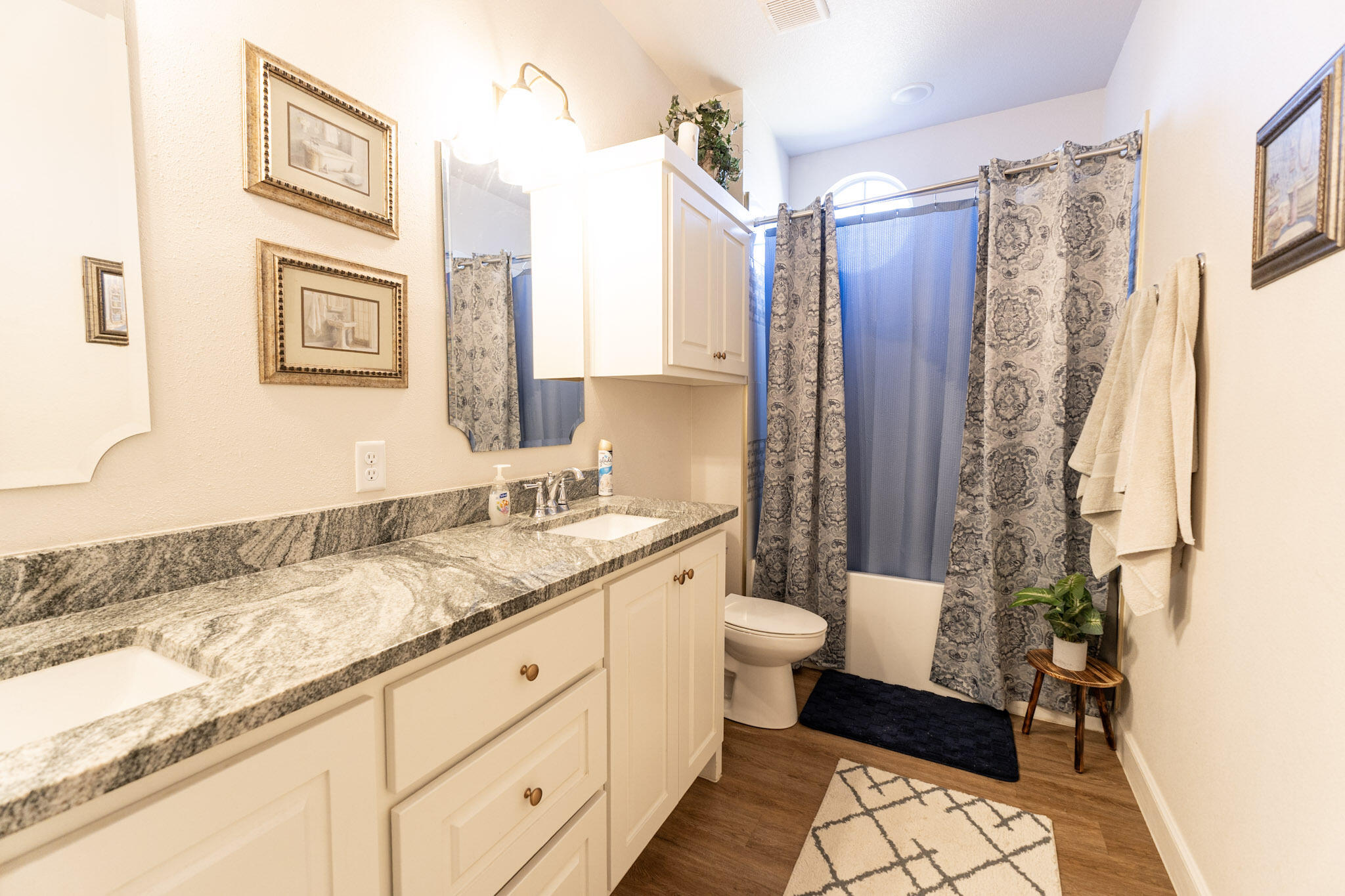 6801 51st Street Lubbock, TX 79407 - Photo 13 of 19 a bathroom with a granite countertop sink toilet and shower