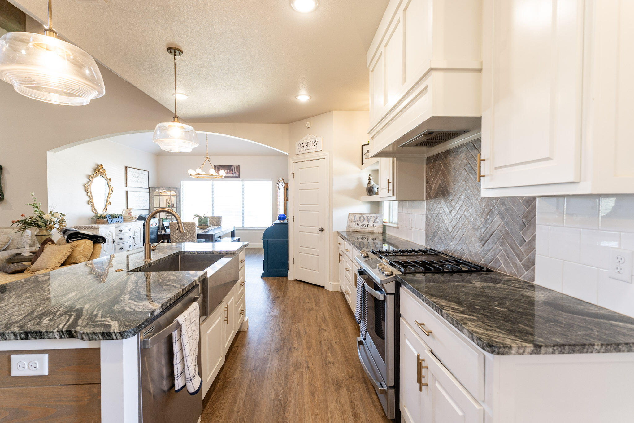 6801 51st Street Lubbock, TX 79407 - Photo 6 of 19 a kitchen with kitchen island granite countertop a stove and a sink