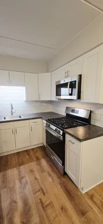 a kitchen with granite countertop a stove and a sink