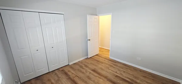 a view of a room with wooden floor