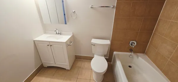a bathroom with a sink and mirror with toilet