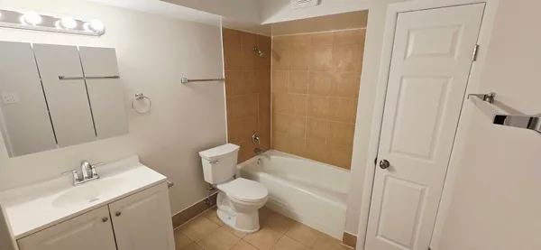 a white toilet sitting next to a bathroom sink