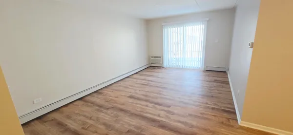 a view of an empty room and wooden floor