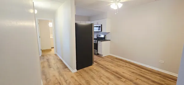 a view of hallway with wooden floor