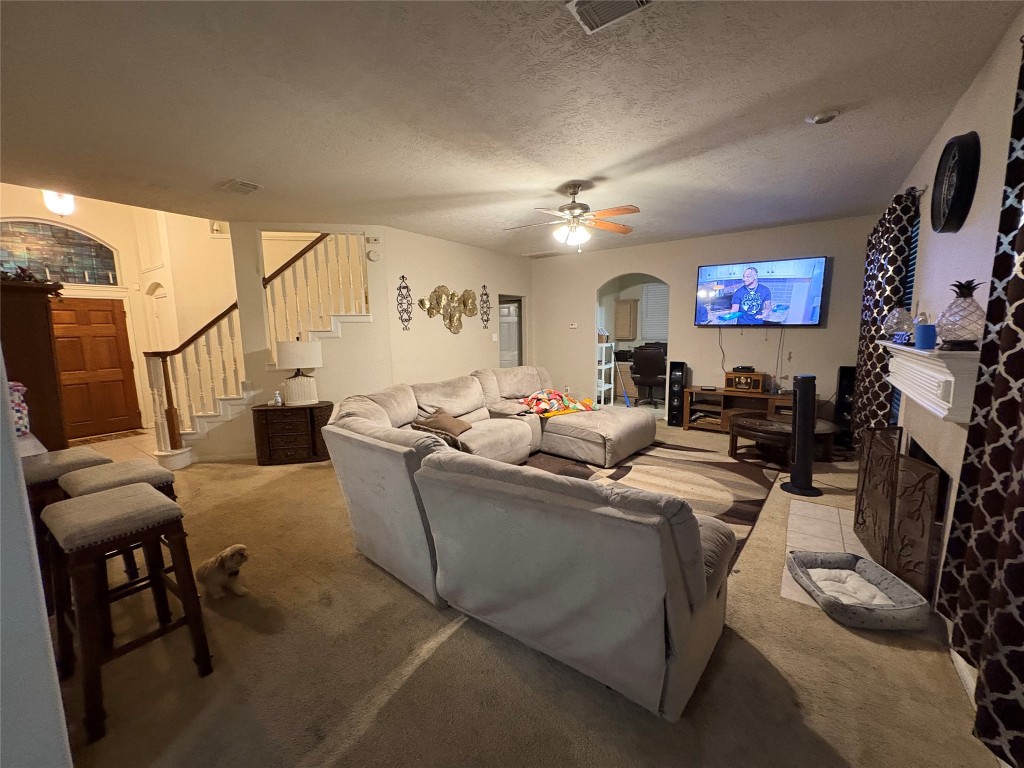 13801 Stark Bridge Lane Rosharon, TX 77583 - Photo 6 of 17 a living room with furniture a fireplace and a flat screen tv